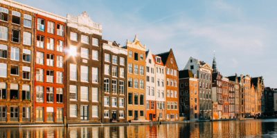 assorted-color buildings beside body of water