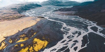aerial view of black and white mountains under cloudy sky during daytime